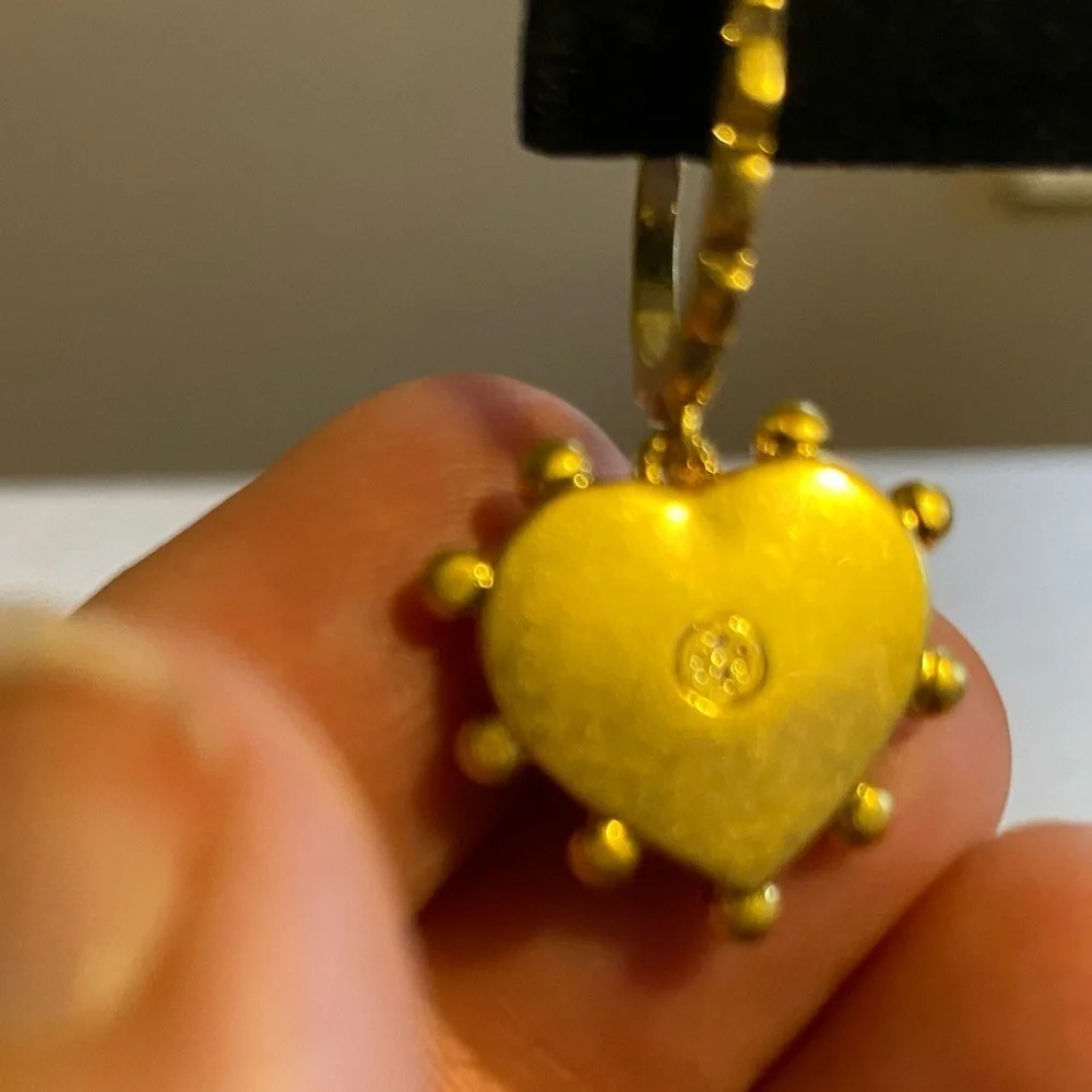 Tory Burch blue lapis heart drops hanging from huggie hoops.